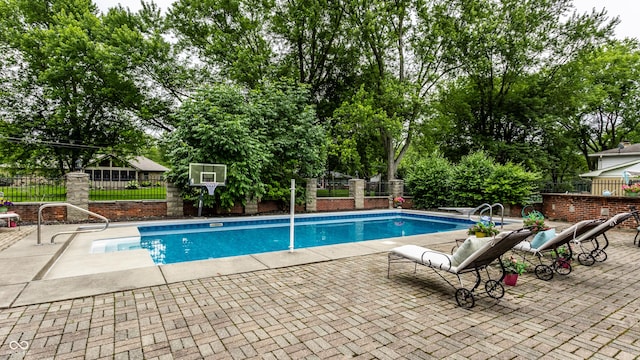 7743 Camelback Dr, Indianapolis, IN 46250 - view of pool with view of wooded area and a patio area