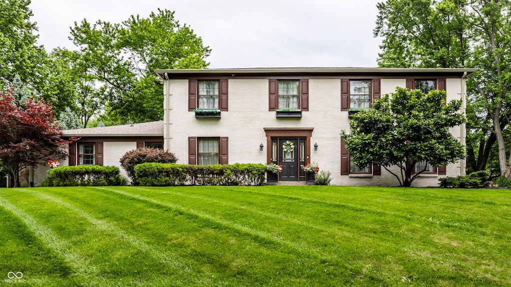 7743 Camelback Dr, Indianapolis, IN 46250 - view of front facade with a front yard and brick siding