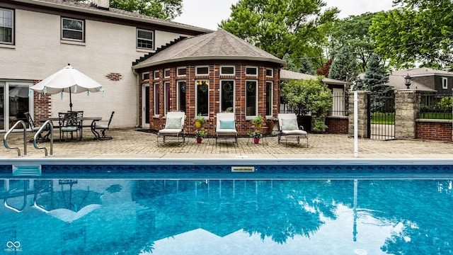 7743 Camelback Dr, Indianapolis, IN 46250 - view of pool featuring a patio and an outbuilding