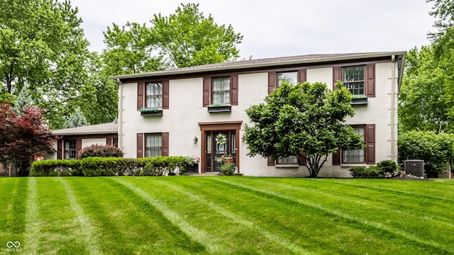 7743 Camelback Dr, Indianapolis, IN 46250 - colonial house with a front lawn and brick siding