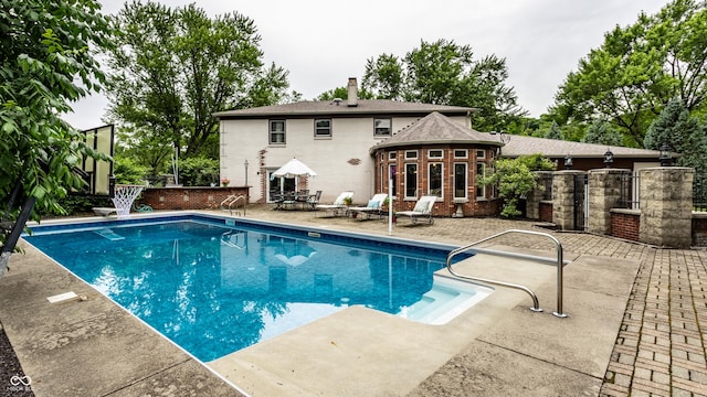7743 Camelback Dr, Indianapolis, IN 46250 - view of swimming pool with a patio and a diving board