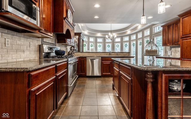 7743 Camelback Dr, Indianapolis, IN 46250 - kitchen featuring appliances with stainless steel finishes, backsplash, a peninsula, recessed lighting, and healthy amount of natural light