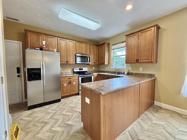 5571 Auburndale Dr, Bargersville, IN 46106 - kitchen featuring appliances with stainless steel finishes, brown cabinetry, a peninsula, and recessed lighting