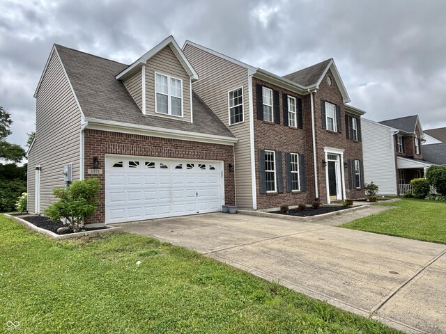 5571 Auburndale Dr, Bargersville, IN 46106 - colonial inspired home with driveway, brick siding, a front lawn, and roof with shingles