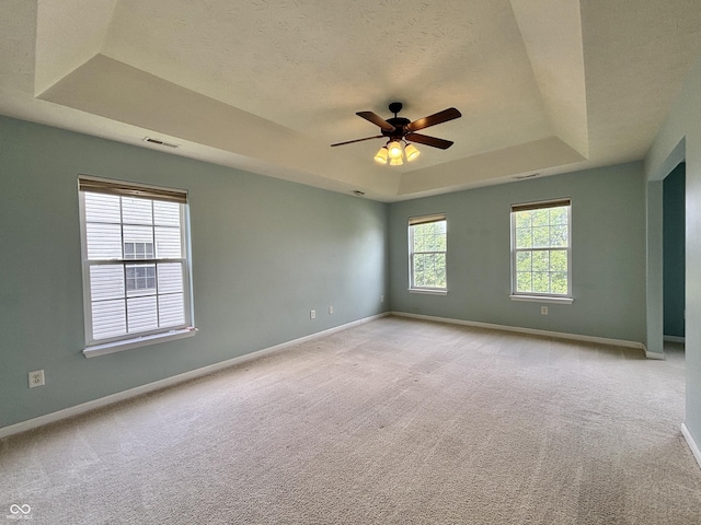 5571 Auburndale Dr, Bargersville, IN 46106 - empty room featuring a raised ceiling, light carpet, ceiling fan, and a textured ceiling