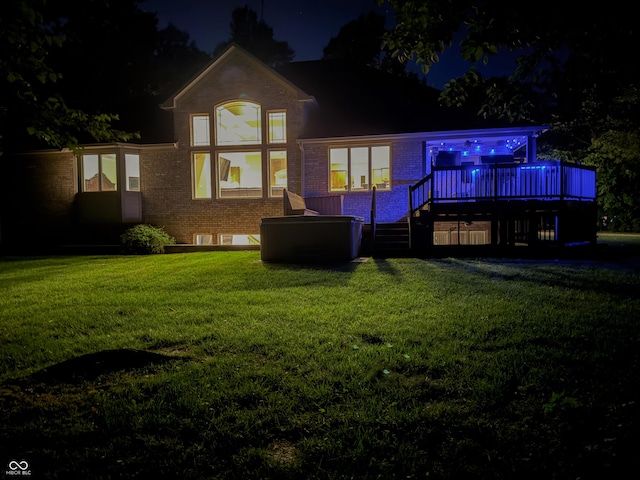 23119 Sonoma Ln, Cicero, IN 46034 - back of house at night featuring brick siding, a lawn, and stairway