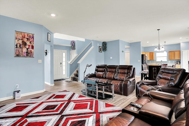 1571 N Creekwater Pass, Greenfield, IN 46140 - living area with light wood-style flooring, stairs, a chandelier, and recessed lighting
