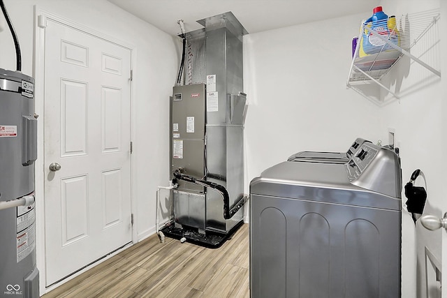 1571 N Creekwater Pass, Greenfield, IN 46140 - laundry room with washer and dryer, electric water heater, light wood-type flooring, and heating unit