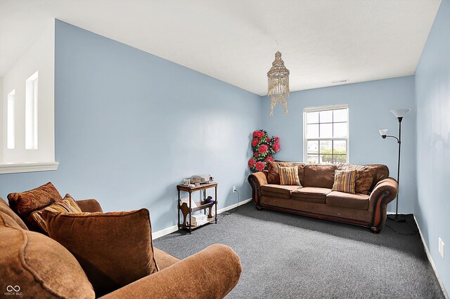 1571 N Creekwater Pass, Greenfield, IN 46140 - carpeted living room with baseboards and a chandelier