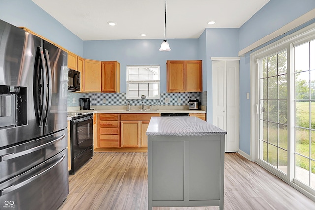 1571 N Creekwater Pass, Greenfield, IN 46140 - kitchen with black appliances, backsplash, light countertops, healthy amount of natural light, and recessed lighting