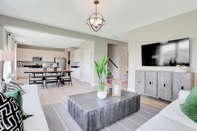 16876 Daly Dr, Noblesville, IN 46062 - living room featuring light wood-type flooring, a chandelier, and recessed lighting
