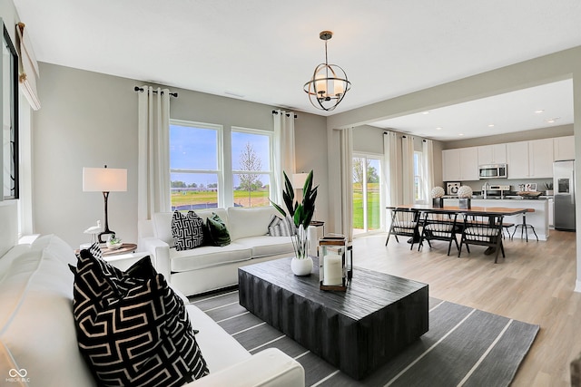 16876 Daly Dr, Noblesville, IN 46062 - living area with light wood-style floors, a chandelier, and recessed lighting