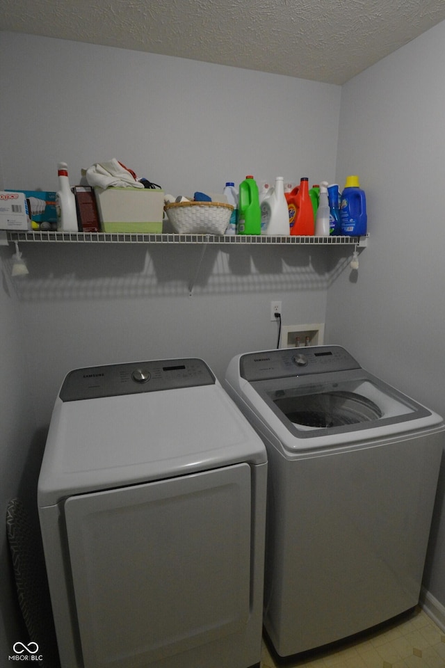 12389 Titans Dr, Fishers, IN 46037 - laundry area with separate washer and dryer and a textured ceiling