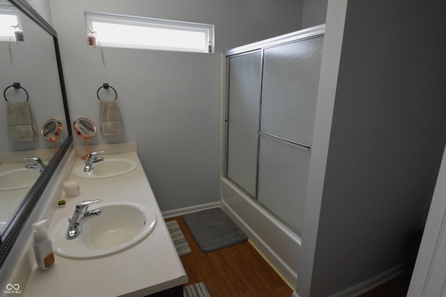 12389 Titans Dr, Fishers, IN 46037 - bathroom with double vanity, combined bath / shower with glass door, and wood finished floors