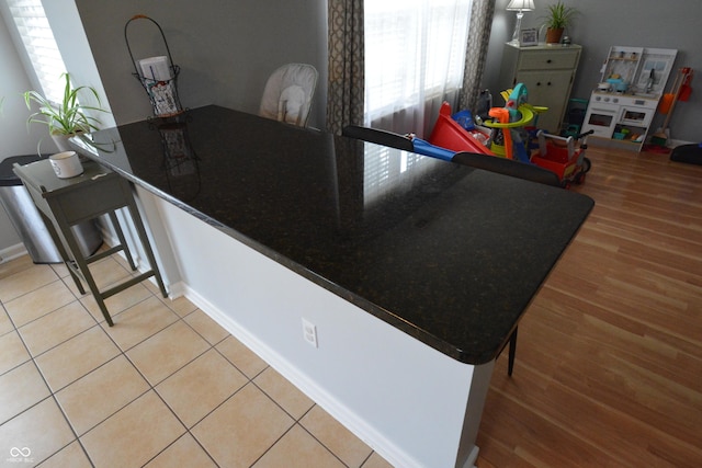 12389 Titans Dr, Fishers, IN 46037 - kitchen with light wood-style floors and baseboards