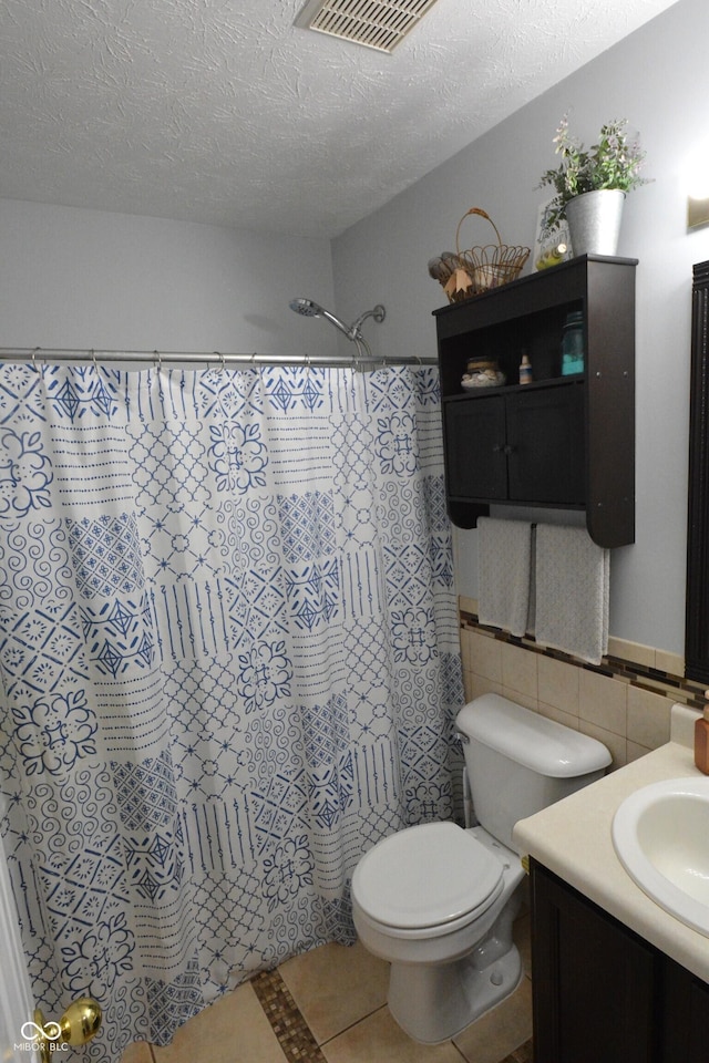 12389 Titans Dr, Fishers, IN 46037 - full bath featuring vanity, curtained shower, tile walls, a textured ceiling, and tile patterned flooring