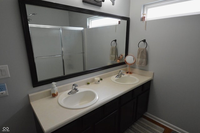 12389 Titans Dr, Fishers, IN 46037 - bathroom with healthy amount of natural light, double vanity, and an enclosed shower