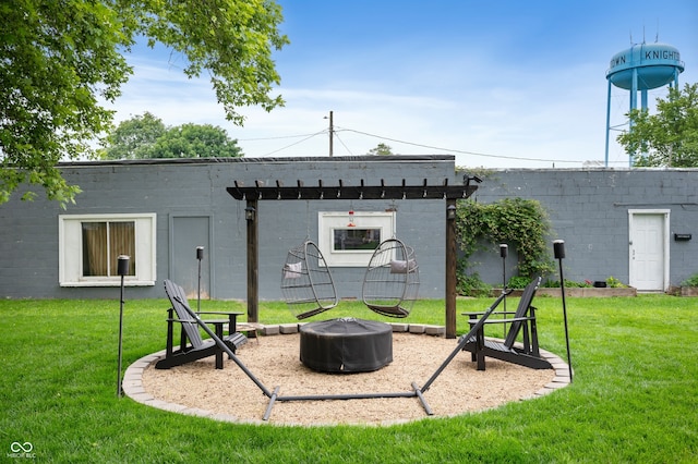 284 E Silver St, Knightstown, IN 46148 - rear view of property featuring concrete block siding, an outdoor fire pit, and a yard