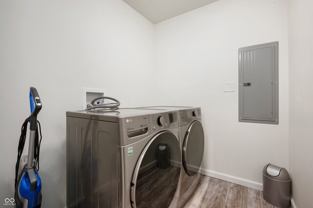 284 E Silver St, Knightstown, IN 46148 - laundry area with electric panel, washer and dryer, and wood finished floors