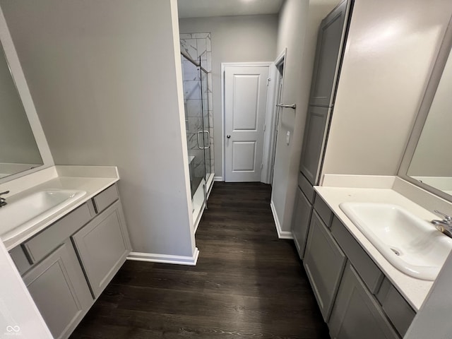 6729 Birmingham Ave, Mccordsville, IN 46055 - bathroom with two vanities, a shower stall, and wood finished floors