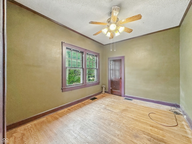 1011 W 7th St, Anderson, IN 46016 - unfurnished room with crown molding, light wood finished floors, ceiling fan, and a textured ceiling