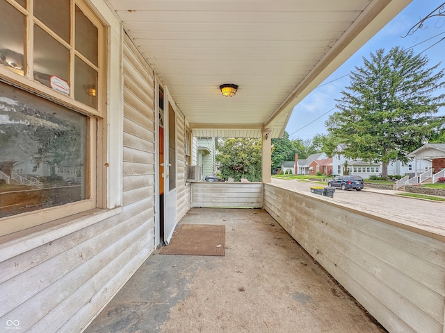 1011 W 7th St, Anderson, IN 46016 - covered porch featuring a residential view and cooling unit