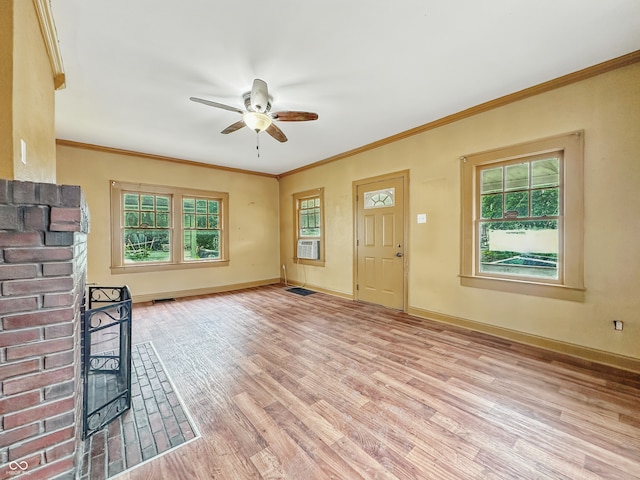 1011 W 7th St, Anderson, IN 46016 - unfurnished living room featuring light wood-style floors, ceiling fan, cooling unit, plenty of natural light, and crown molding