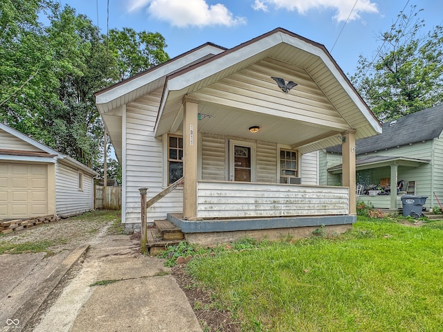 1011 W 7th St, Anderson, IN 46016 - shotgun-style home with covered porch and dirt driveway