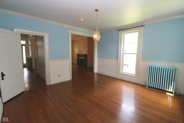 611 E Wabash Ave, Crawfordsville, IN 47933 - unfurnished room with radiator, a wainscoted wall, wood finished floors, and ornamental molding