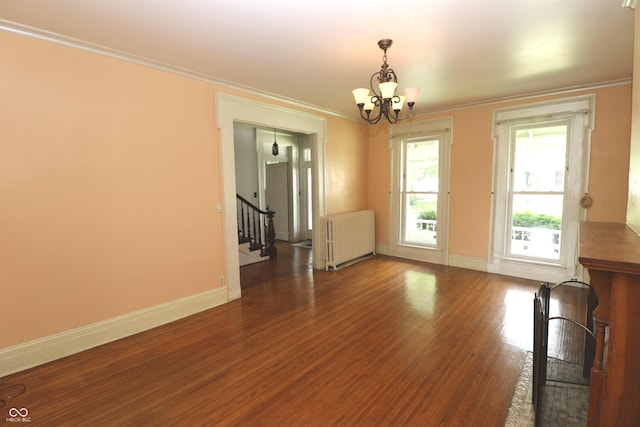 611 E Wabash Ave, Crawfordsville, IN 47933 - unfurnished dining area with radiator, a chandelier, stairway, wood finished floors, and ornamental molding