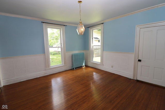 611 E Wabash Ave, Crawfordsville, IN 47933 - empty room with radiator heating unit, wainscoting, wood finished floors, and ornamental molding