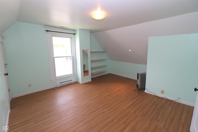 611 E Wabash Ave, Crawfordsville, IN 47933 - bonus room with a baseboard radiator, lofted ceiling, radiator heating unit, and light wood finished floors