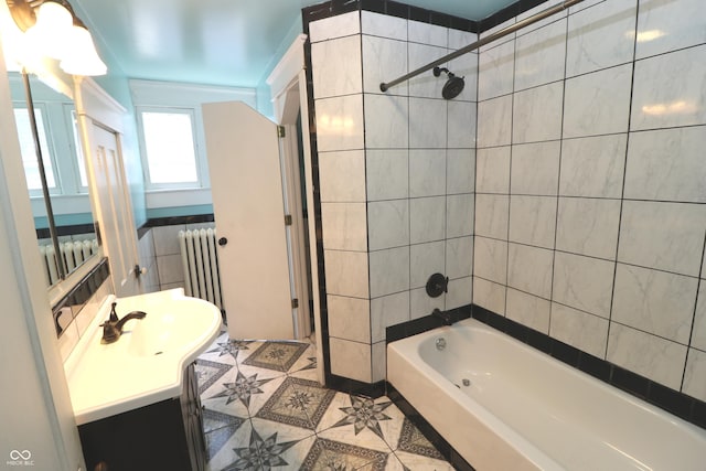 611 E Wabash Ave, Crawfordsville, IN 47933 - bathroom featuring vanity, bathtub / shower combination, radiator heating unit, tile walls, and tile patterned floors