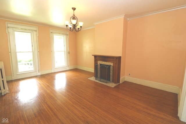 611 E Wabash Ave, Crawfordsville, IN 47933 - unfurnished living room featuring a chandelier, crown molding, wood finished floors, and a fireplace with flush hearth