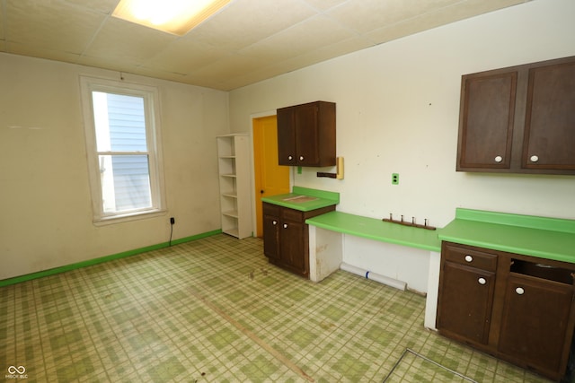 611 E Wabash Ave, Crawfordsville, IN 47933 - kitchen featuring light floors and dark brown cabinetry