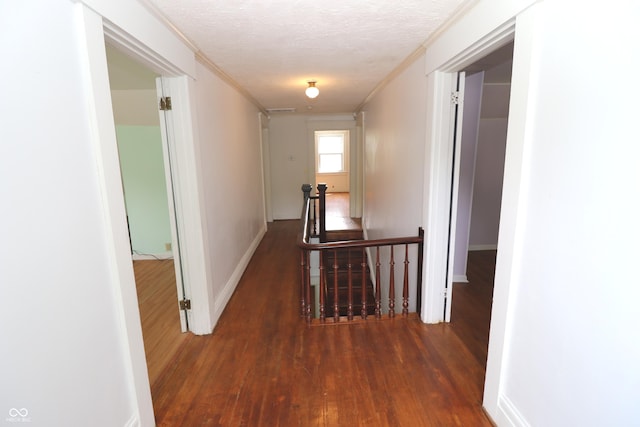 611 E Wabash Ave, Crawfordsville, IN 47933 - hallway with an upstairs landing, wood finished floors, ornamental molding, and a textured ceiling