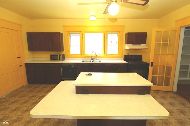 611 E Wabash Ave, Crawfordsville, IN 47933 - kitchen with gas range, a kitchen island, under cabinet range hood, ceiling fan, and light countertops