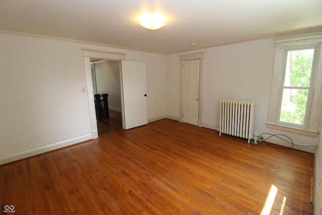 611 E Wabash Ave, Crawfordsville, IN 47933 - spare room with radiator, light wood-style flooring, and ornamental molding