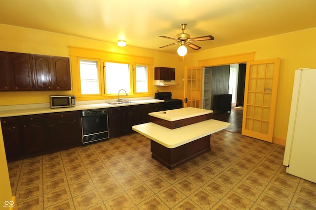 611 E Wabash Ave, Crawfordsville, IN 47933 - kitchen featuring black dishwasher, stainless steel microwave, freestanding refrigerator, light countertops, and a kitchen island