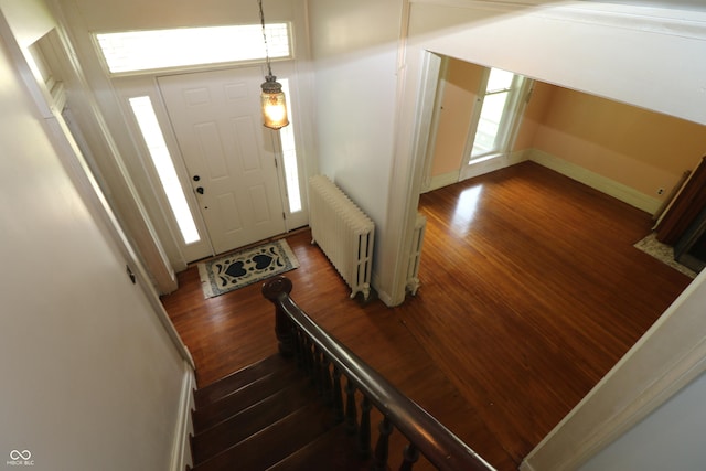 611 E Wabash Ave, Crawfordsville, IN 47933 - foyer entrance with radiator heating unit, wood finished floors, and plenty of natural light