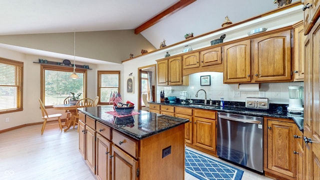 8818 Mathews Rd, Indianapolis, IN 46259 - kitchen featuring stainless steel dishwasher, light wood finished floors, brown cabinetry, dark stone countertops, and tasteful backsplash