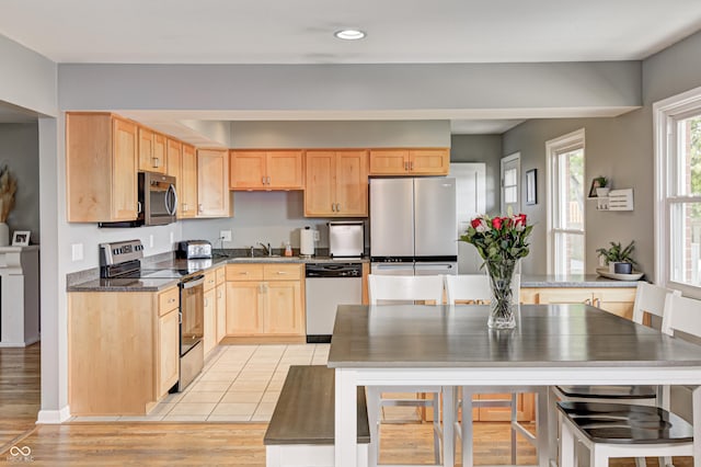 6143 Schoolwood Dr, Indianapolis, IN 46224 - kitchen featuring stainless steel appliances, light brown cabinets, recessed lighting, light wood-style floors, and dark countertops