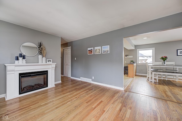 6143 Schoolwood Dr, Indianapolis, IN 46224 - living room with light wood-type flooring and a glass covered fireplace