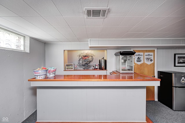 6143 Schoolwood Dr, Indianapolis, IN 46224 - bar area with freestanding refrigerator, wood walls, and carpet