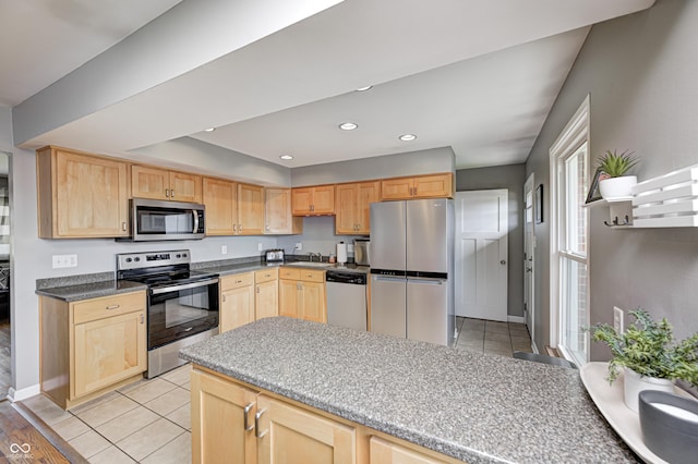 6143 Schoolwood Dr, Indianapolis, IN 46224 - kitchen with appliances with stainless steel finishes, light brown cabinetry, recessed lighting, light tile patterned flooring, and a raised ceiling