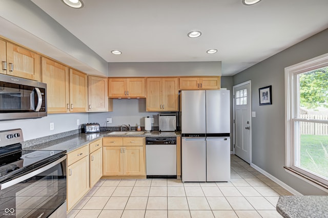 6143 Schoolwood Dr, Indianapolis, IN 46224 - kitchen with appliances with stainless steel finishes, light brown cabinets, light tile patterned floors, recessed lighting, and dark countertops
