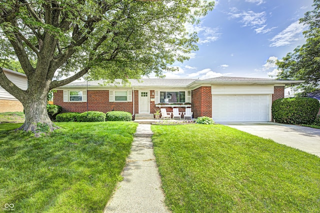 6143 Schoolwood Dr, Indianapolis, IN 46224 - ranch-style home with brick siding, an attached garage, concrete driveway, and a front yard