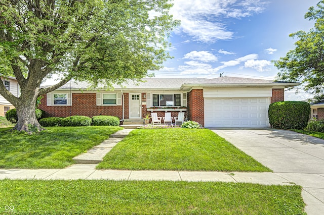 6143 Schoolwood Dr, Indianapolis, IN 46224 - ranch-style house featuring an attached garage, concrete driveway, brick siding, and a front yard