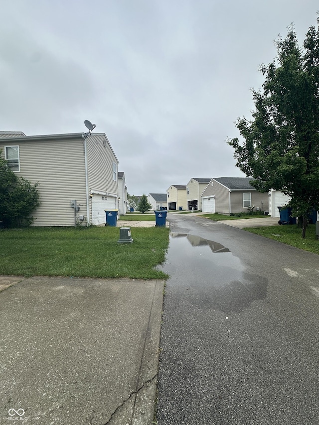 12639 Justice Xing, Fishers, IN 46037 - view of asphalt road featuring a residential view