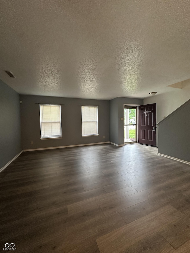 12639 Justice Xing, Fishers, IN 46037 - spare room featuring a textured ceiling and dark wood-style floors